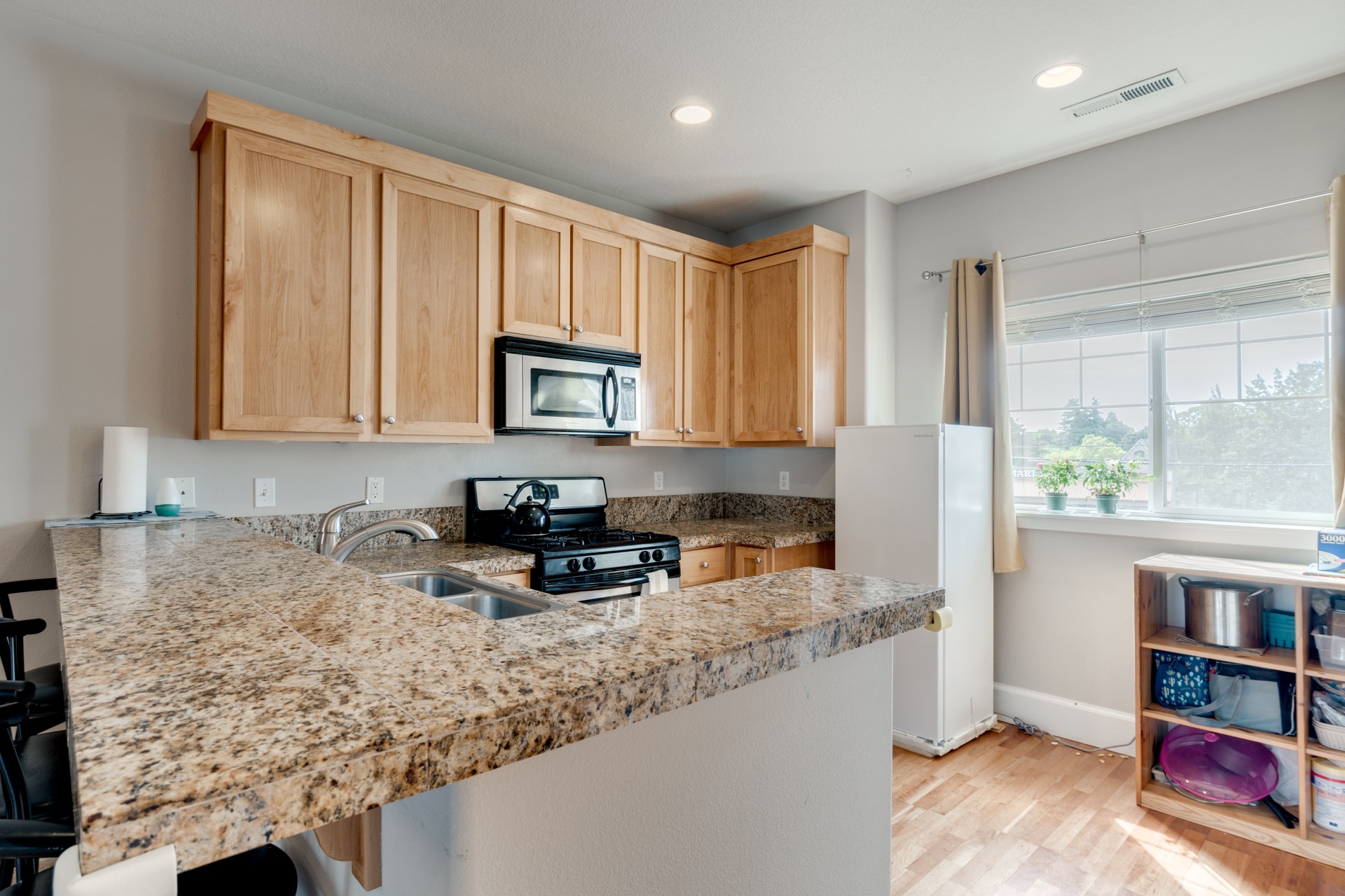 Kitchen with granite countertops and stainless appliances 